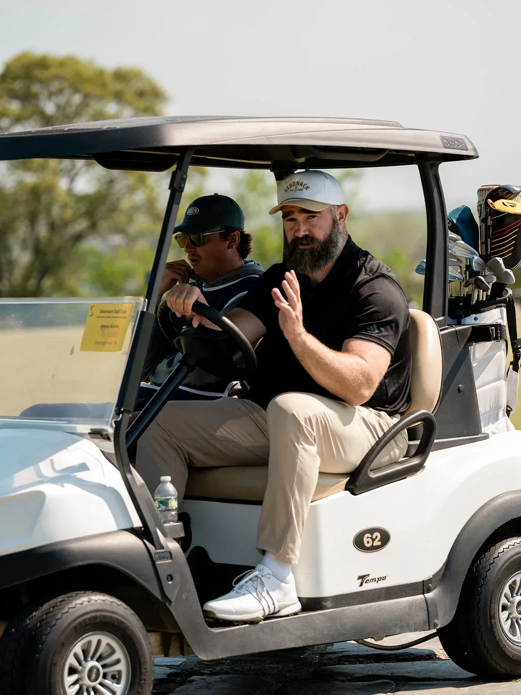 Players heading out in a cart at the Blue & Gold Classic